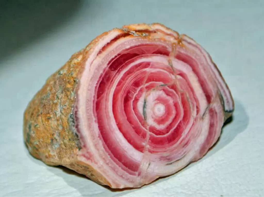Rhodochrosite rock, pink and white concentric circles that make it look like a cooked ham.