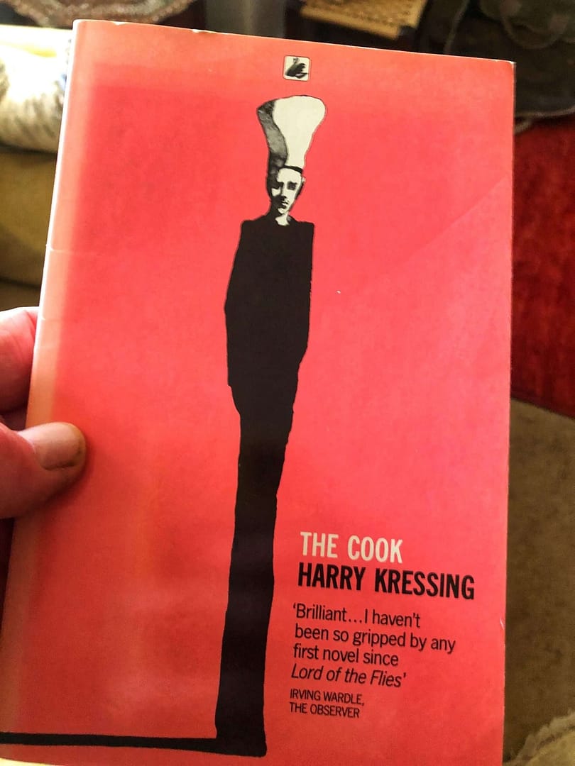 This book cover is by the wonderful Milton Glser. It shows an incredibly thin, tall man, dressed all in black apart from the white of his chefs' hat. He's casting a drk shadow across the pink background. 