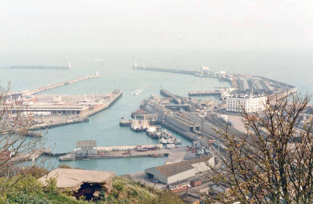 View SE from South Military Road by the remains of the Knights Templar church. in the foreground is the Lifeboat Station, then on the left of the Western Docks basin is Prince of Wales Pier, in the centre is Dover Marine ex-SE&CR terminus and the Hovercraft Ferry terminal, then beyond the (white, former) Lord Warden Hotel, on the right stretches the Admiralty Pier. The Marine Station was built 2/1915, for military use as Dover Admiralty Pier Station, used for civilian use from 1/19 and named Dover Marine until 1979 then Dover Western Docks, until closed 11/94 when it was transformed into the Dover Cruise Terminal.