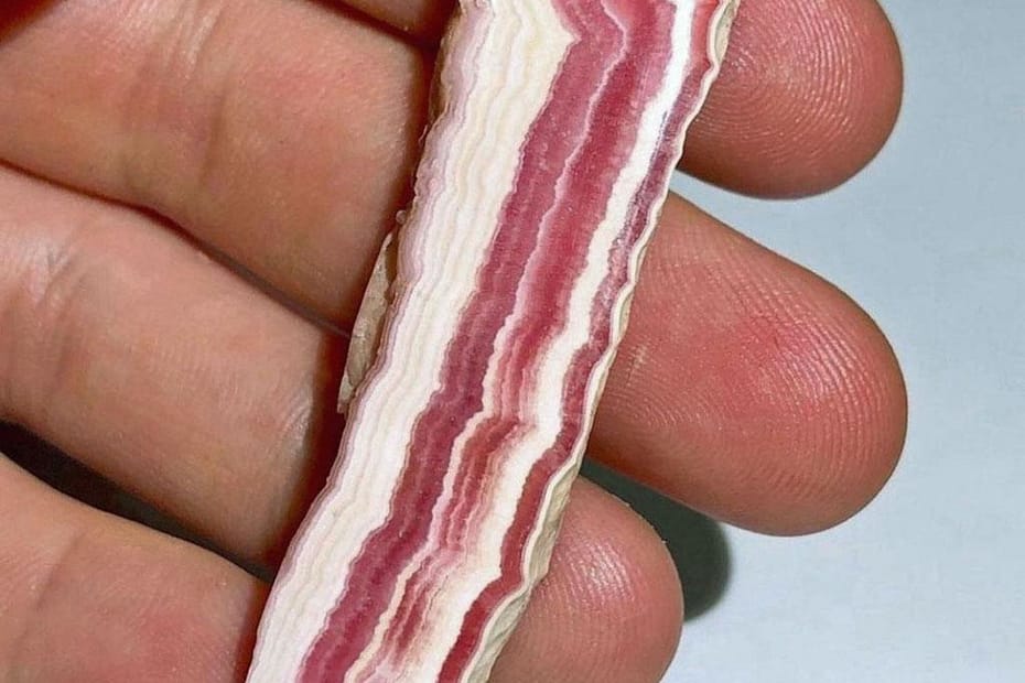 Rhodochrosite rock, pink and white layers that make it look like a slice of bacon.